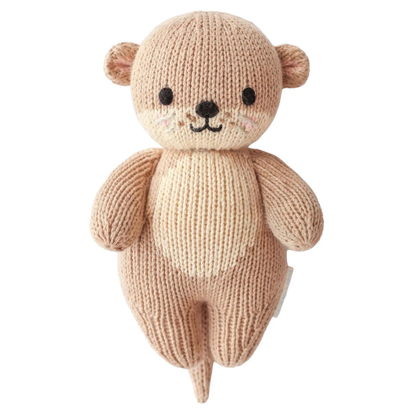 Mini Otter hand-knit baby doll by Cuddle + Kind, soft and adorable plush toy with detailed knitting, perfect for cuddling.