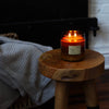 Dilo No. 03 Tobacco + Cedar candle in a glass holder, featuring warm amber wax and a wooden wick, ideal for cozy ambiance.