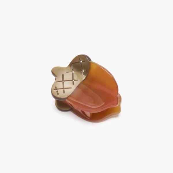 Acorn-shaped hair clip on a white background