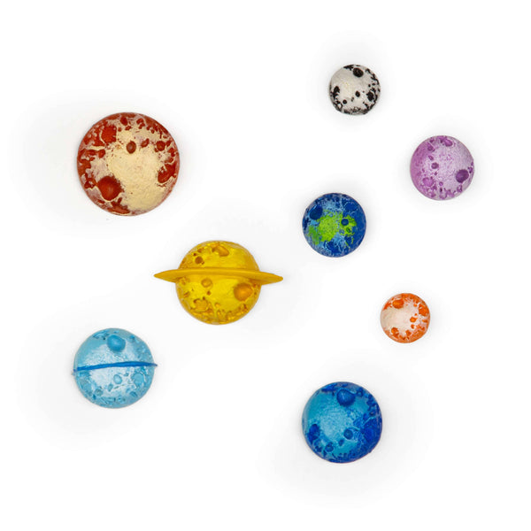 Set of 8 Planet Mighties magnets by Three by Three Seattle, colorful space-themed home accessories on a white background.