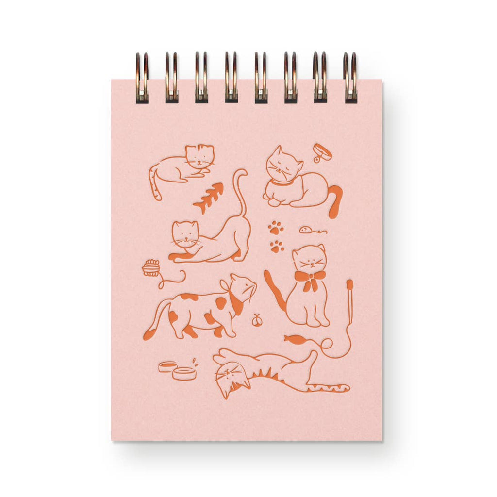 Notebook with cat illustrations on a pink cover against a white background