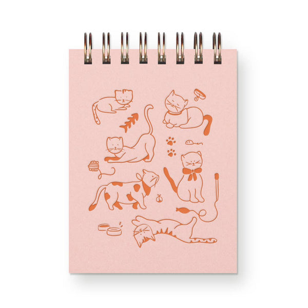 Notebook with cat illustrations on a pink cover against a white background