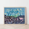 A framed painting of white daisies with yellow centers and blue stems, set against a dark patterned ground, leaning against a white wall on a light wood floor.