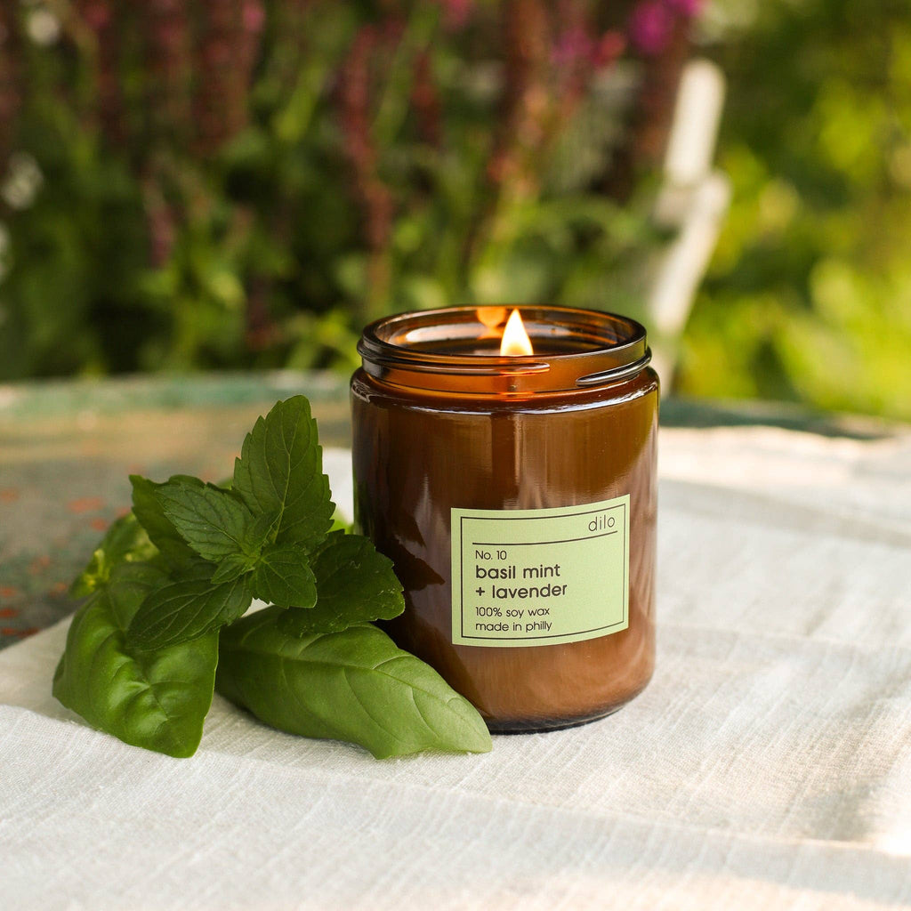 Dilo No. 10 Basil Mint and Lavender candle in a glass holder, showcasing fresh herbs and floral scents.