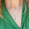 handamde Gold necklace with a tiny pendant with green crystals