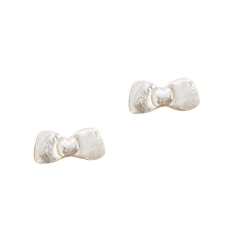 Tiny bow handmade sterling silver stud earrings by Chocolate and Steel, featuring delicate, polished silver bows on classic studs.