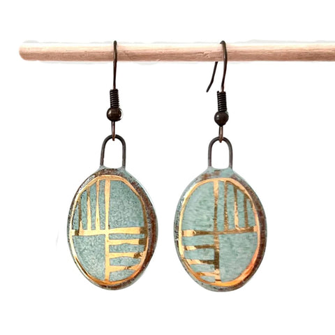 Turquoise oval earrings with gold checkered lines from The Artifact House, showcasing intricate design and vibrant color.