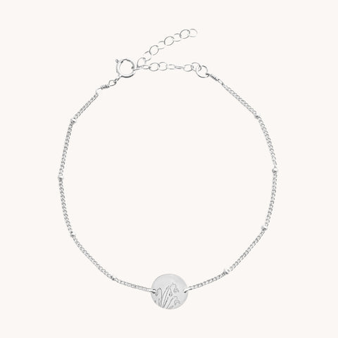Silver January Snowdrop Birth Flower Bracelet by Gratinsta featuring delicate snowdrop flower charm and intricate silver design.