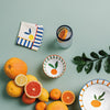 Decorative plates with fruit designs on a green background