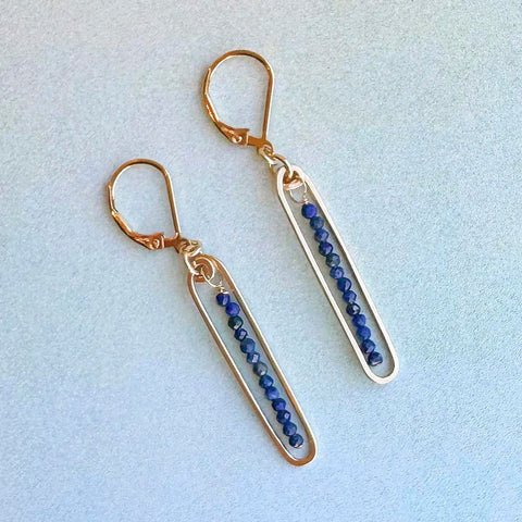 Freshie & Zero lyric earrings featuring blue lapis stones, showcasing elegant dangle earrings with vibrant blue gemstone accents.