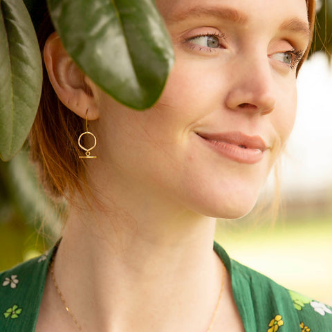Mini Mantra Earrings by Freshie & Zero featuring small, delicate hoop earrings with engraved mantra designs.