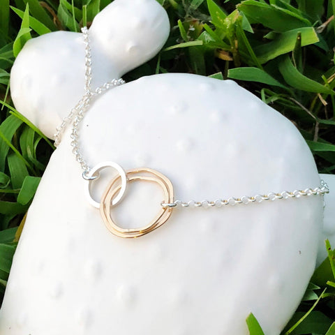 Gold necklace from Freshie & Zero with a radiant pendant, showcasing a sleek and elegant jewelry piece.