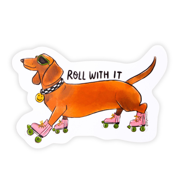A die-cut sticker featuring a cartoon dachshund wearing pink roller skates and sunglasses, with the text 'ROLL WITH IT' written across the dog, on a white background.