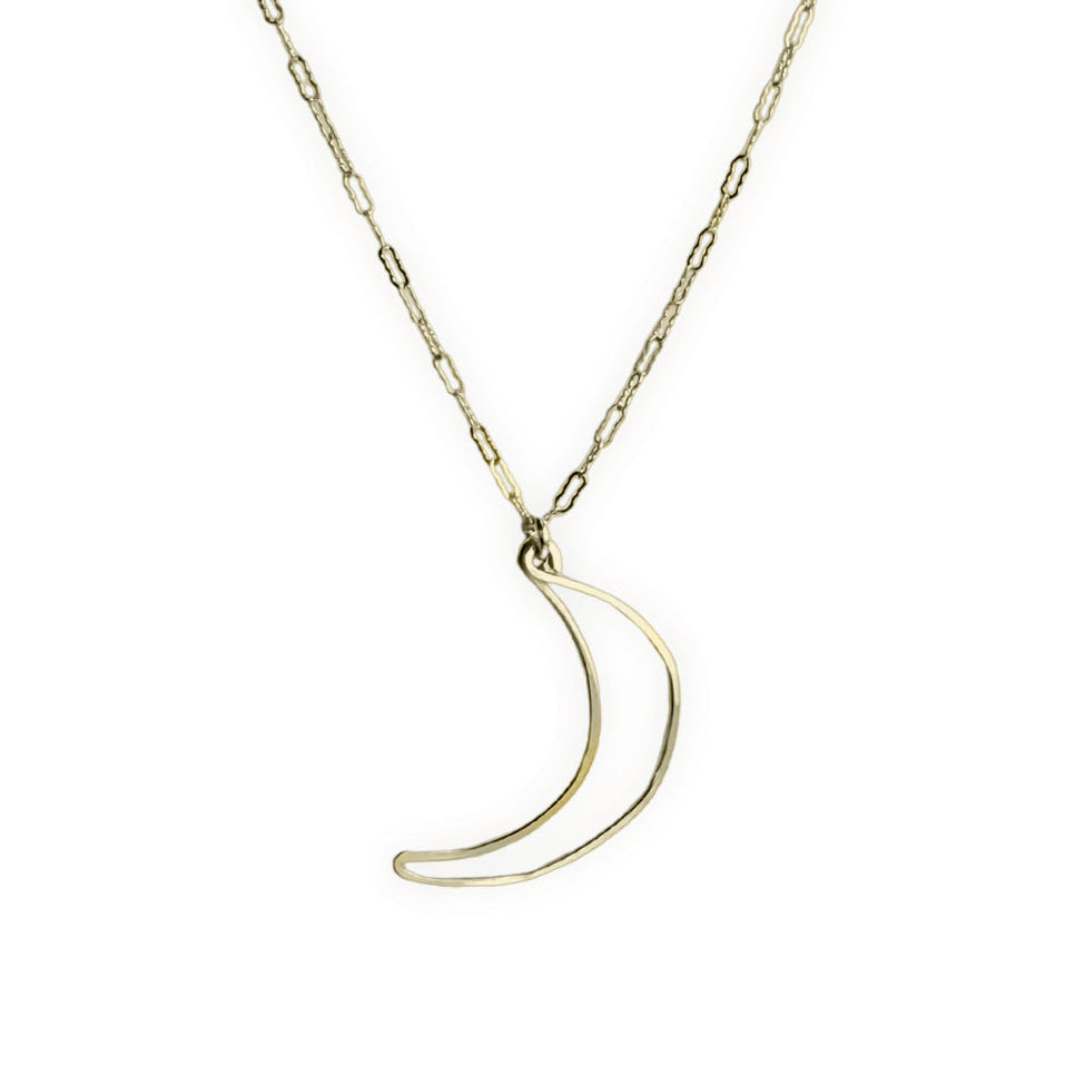 A delicate gold chain necklace featuring a thin, open crescent moon pendant, displayed against a solid white background.