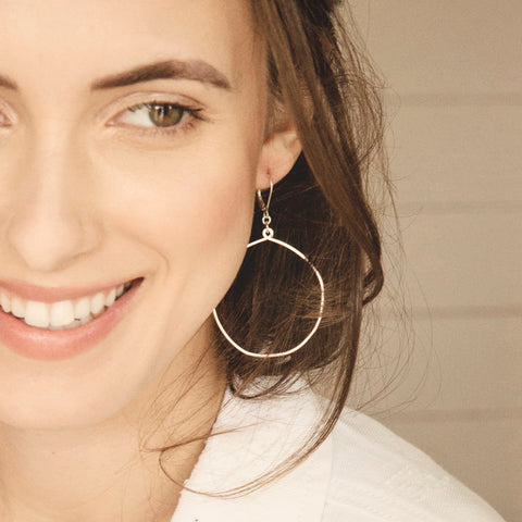 Freshie & Zero Wander earrings featuring delicate, handcrafted silver hoops with intricate leaf designs.