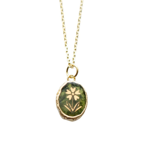 Gold flower pendant on green vessonite gemstone necklace by Jill Makes, featuring intricate floral design and vibrant green gemstone.