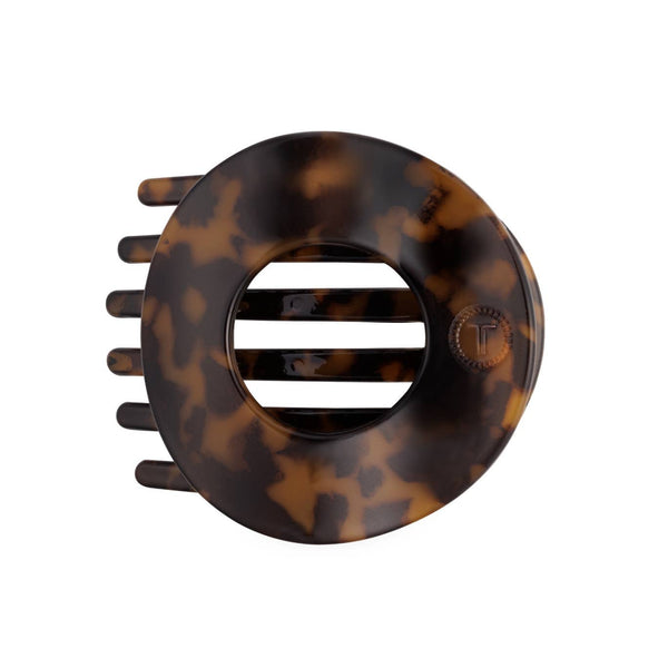 Tortoise medium flat circle TELETIES hair clip, a stylish hair accessory for securing hair comfortably and securely.