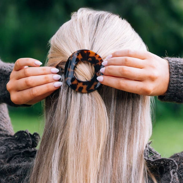 Small tortoise Teleties Flat Circle Hair Clip for securing hair, made by TELETIES, shown in close-up view.