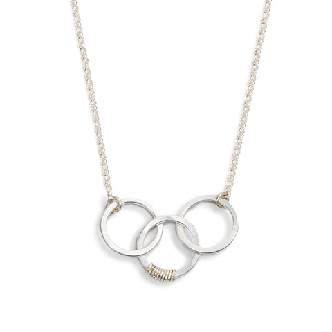 Freshie & Zero cartwheel necklace featuring a family of three, delicate pendant necklace with detailed family charm.