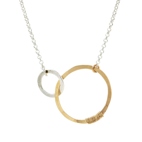 Silver mother and child love necklace by Freshie & Zero featuring a heart-shaped pendant with engraved detailing.
