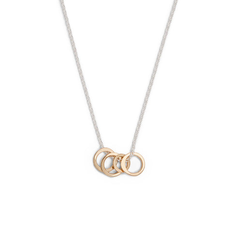 Family of four cluster necklace by Freshie & Zero featuring intertwined silver chain links and custom family pendant design.