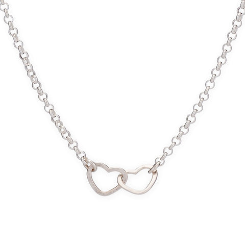 Two tiny hearts necklaces by Freshie & Zero featuring delicate gold chain and small heart pendants, close-up view.