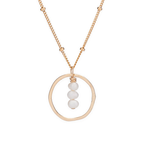 White pearl treble necklace by Freshie & Zero, featuring elegant string of pearls on a delicate chain.
