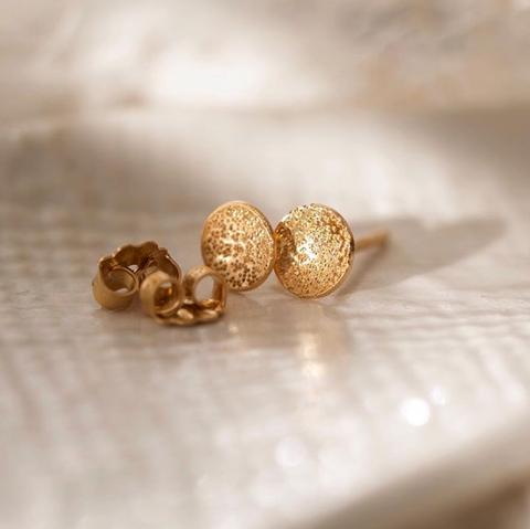 Mini Christina Kober stud earrings with circle dot design and diamond dust detail, showcasing sleek, modern jewelry.
