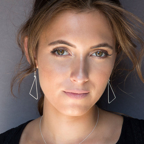 Freshie & Zero pivot earrings showing sleek, modern earrings with a pivot design, made of shiny metal on a plain background.