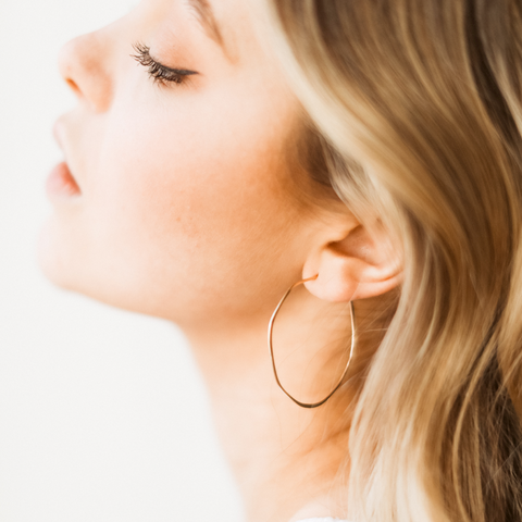 Large minimal organic circle hoops earrings by Freshie & Zero displayed on a model, showcasing their sleek, modern design.